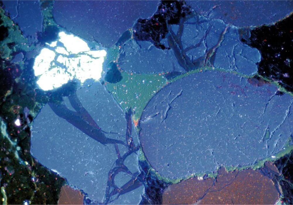 Cathodoluminescence image showing compaction induced microfactures, later healed by late stage dark blue poorly luminescent quartz cement